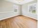 Bright bedroom with hardwood floors, large windows offering natural light, and neutral wall color at 2920 Lincoln St, Anderson, IN 46016
