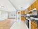 Kitchen with wooden cabinets, appliances and view to the living room at 2920 Lincoln St, Anderson, IN 46016