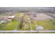 Scenic aerial view showcases the sprawling property, featuring multiple buildings, and a charming pond at 3110 S County Road 225 East, Danville, IN 46122