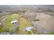 Aerial view of a large property with outbuildings, barns, large grassy areas and agricultural fields at 3110 S County Road 225 East, Danville, IN 46122