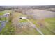 Expansive aerial view captures the property's lush landscaping, multiple buildings, and farm land at 3110 S County Road 225 East, Danville, IN 46122