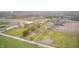 High aerial view of the sprawling estate highlighting its buildings, pond, and surrounding farm land at 3110 S County Road 225 East, Danville, IN 46122