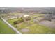 Vast aerial view of the farm, showing its fields, buildings, pond, and road access at 3110 S County Road 225 East, Danville, IN 46122