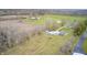 Aerial view showing a house and sheds on a large lot with gravel areas and open fields at 3110 S County Road 225 East, Danville, IN 46122