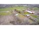 A bird's eye view showcases several homes and barns in a bucolic rural setting at 3110 S County Road 225 East, Danville, IN 46122