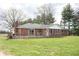 Rear view of the brick home with an attached deck, and chimney at 3110 S County Road 225 East, Danville, IN 46122