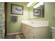Bathroom with neutral-colored vanity, stylish mirror, and decorative painting of deer in a winter landscape at 3110 S County Road 225 East, Danville, IN 46122