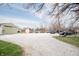 Gravel driveway leading to a green storage building, with visible parking for multiple vehicles at 3110 S County Road 225 East, Danville, IN 46122