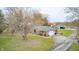 Aerial view showcases the house, attached garage, and driveway situated in a large grassy yard at 3110 S County Road 225 East, Danville, IN 46122
