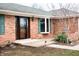 Brick home's front door is flanked by a bay window and trimmed with matching green shutters at 3110 S County Road 225 East, Danville, IN 46122