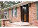 Inviting brick porch featuring green shutters and a stately lantern fixture at 3110 S County Road 225 East, Danville, IN 46122
