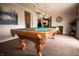 Spacious game room featuring a well-maintained pool table under elegant lighting at 3110 S County Road 225 East, Danville, IN 46122