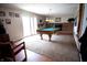 An expansive game room featuring a pool table, fireplace, and sliding glass doors at 3110 S County Road 225 East, Danville, IN 46122