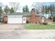 Brick garage features a white door, side deck, and a tidy side yard at 3110 S County Road 225 East, Danville, IN 46122