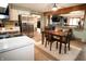 Spacious kitchen with stainless steel appliances, a wooden dining table, and convenient access to the living area at 3110 S County Road 225 East, Danville, IN 46122