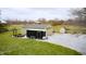 Rear exterior view showcases the property's outbuildings, sheds, trailer, and ample storage and workspace at 3110 S County Road 225 East, Danville, IN 46122