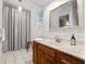 Classic bathroom featuring a wood vanity, marble countertop, and shower with neutral tones at 315 Sunset Dr, Columbus, IN 47201
