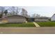Charming single-story home with a manicured lawn and a welcoming blue front door at 315 Sunset Dr, Columbus, IN 47201