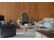 Elegant living room featuring wood paneling, eclectic furniture, and decorative mirror at 315 Sunset Dr, Columbus, IN 47201