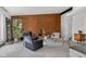 Cozy living room featuring wood paneling, modern furniture, and a large window providing natural light at 315 Sunset Dr, Columbus, IN 47201