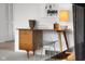 Stylish office space with a wooden desk, wire chair, decorative lamp, and ample natural light at 315 Sunset Dr, Columbus, IN 47201