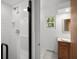 Clean shower room in neutral tones adjacent to a bathroom with wood vanity at 315 Sunset Dr, Columbus, IN 47201