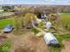 Extensive farm property featuring a house, barns, and silos, set amidst vast open fields and wooded areas at 3308 S 600 E Rd, Waldron, IN 46182