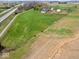 Expansive property featuring a farmhouse, fields, and outbuildings, near both highway and serene farmland at 3308 S 600 E Rd, Waldron, IN 46182