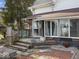 Inviting back porch with wood steps and seating area, perfect for relaxing outdoors at 3308 S 600 E Rd, Waldron, IN 46182