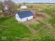 A white barn with a metal roof sits on a lush green field, surrounded by an open fence at 3308 S 600 E Rd, Waldron, IN 46182
