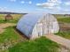 Rustic barn featuring weathered wooden planks, an arched roof, and a secure fence, blending seamlessly with its surroundings at 3308 S 600 E Rd, Waldron, IN 46182