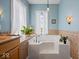 A relaxing soaking tub is framed by a window with natural light and a tiled backsplash at 3308 S 600 E Rd, Waldron, IN 46182