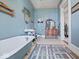 Charming bathroom with clawfoot tub, pedestal sink, and vintage decor at 3308 S 600 E Rd, Waldron, IN 46182