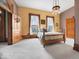 Spacious bedroom with hard wood trim, soft natural light, and carpet flooring at 3308 S 600 E Rd, Waldron, IN 46182