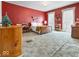 Spacious bedroom with vintage details, red walls, and bright natural light streaming through the white curtains at 3308 S 600 E Rd, Waldron, IN 46182