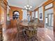 Elegant dining room with hardwood floors, built-in hutch, and classic wood furniture at 3308 S 600 E Rd, Waldron, IN 46182