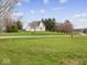 Classic two-story home with manicured lawn and mature trees providing a picturesque setting at 3308 S 600 E Rd, Waldron, IN 46182
