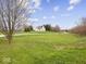 Classic two-story home with manicured lawn and mature trees providing a picturesque setting at 3308 S 600 E Rd, Waldron, IN 46182