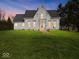 Charming two-story white home boasts meticulous landscaping and a classic architectural design at 3308 S 600 E Rd, Waldron, IN 46182