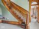 Charming foyer with ornate wood staircase, light green walls, and decorative accents at 3308 S 600 E Rd, Waldron, IN 46182