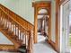 Elegant foyer with stunning wood staircase, decorative millwork, and lovely arched doorway at 3308 S 600 E Rd, Waldron, IN 46182