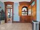 Hallway with stylish tile flooring, decorative millwork, and a functional built-in cabinet at 3308 S 600 E Rd, Waldron, IN 46182