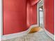 Hallway features a red wall, white trim, hardwood floors near the doorway, and carpeted area at 3308 S 600 E Rd, Waldron, IN 46182