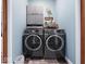 Well-organized laundry area with front load washer and dryer and storage above at 3308 S 600 E Rd, Waldron, IN 46182