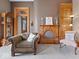 Cozy living room showcasing a decorative fireplace, vintage furniture, and hardwood trim at 3308 S 600 E Rd, Waldron, IN 46182