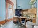 Office space featuring blue walls, wood trim, and a custom desk at 3308 S 600 E Rd, Waldron, IN 46182