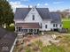 A large white house with a dark roof features an enclosed porch and multiple windows at 3308 S 600 E Rd, Waldron, IN 46182