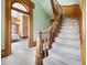 Elegant staircase with detailed wood trim, curved banister, and open view to a bedroom at 3308 S 600 E Rd, Waldron, IN 46182