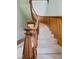 Beautiful wood staircase with carpeted steps and curved banister, offering a grand entrance at 3308 S 600 E Rd, Waldron, IN 46182