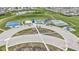 Aerial view shows community amenities: basketball, tennis, playground, parking, and water feature at 3511 Limesprings Ln, Whitestown, IN 46075